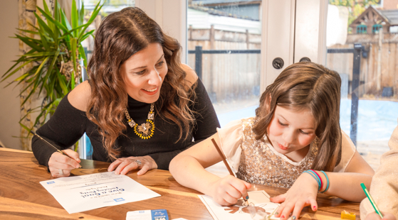 mom teaching young girl