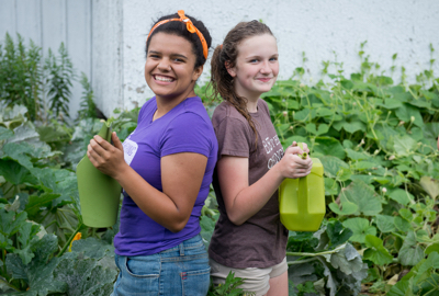 Two volunteers tending to a garden