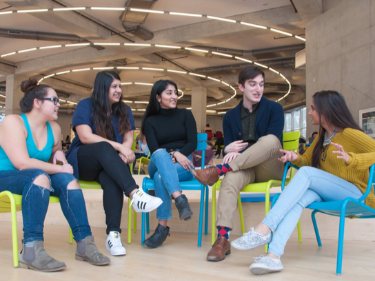 Group of five students sitting together and talking Group of five students sitting together and talking